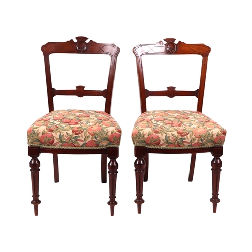 824 - A set of six late Victorian / Edwardian walnut dining chairs with carved back rails, over-stuffed se... 