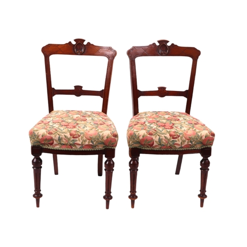 824 - A set of six late Victorian / Edwardian walnut dining chairs with carved back rails, over-stuffed se... 