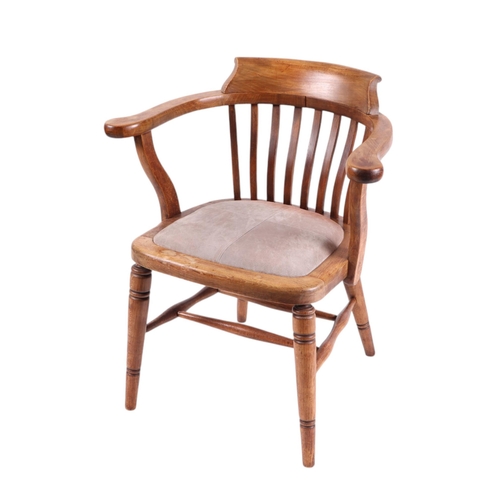 829 - A late 19th / early 20th century stained beech desk chair with upholstered seat and ring turned fron... 