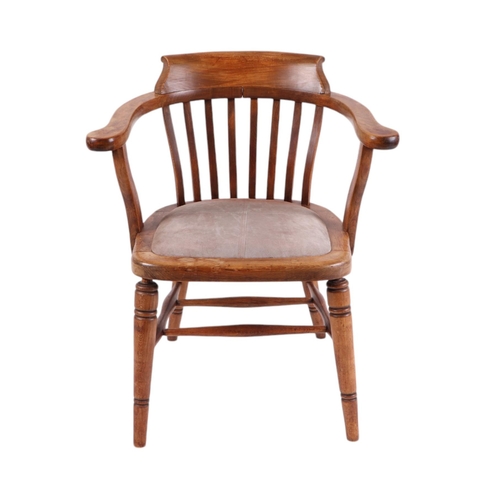 829 - A late 19th / early 20th century stained beech desk chair with upholstered seat and ring turned fron... 