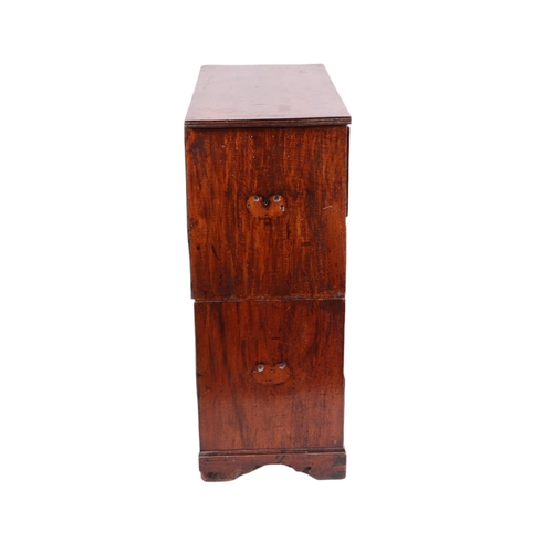 836 - A 19th century teak secretaire Campaign chest of small proportions, the top drawer opening to reveal... 