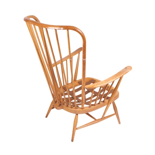 838 - A mid century blonde Ercol stick back armchair.