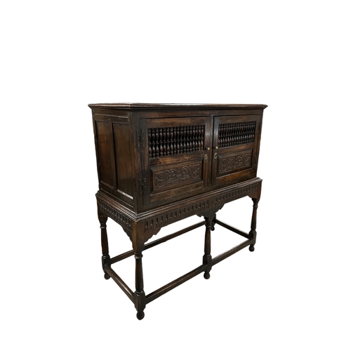 831 - A 17th century Jacobean oak food or dole cupboard on stand, the cabinet with a pair of panelled door... 