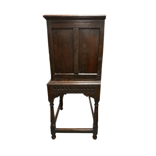 831 - A 17th century Jacobean oak food or dole cupboard on stand, the cabinet with a pair of panelled door... 