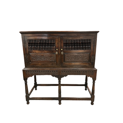 831 - A 17th century Jacobean oak food or dole cupboard on stand, the cabinet with a pair of panelled door... 