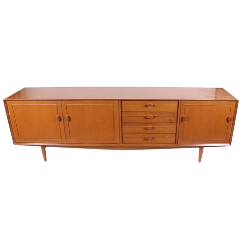 819 - A mid century modern 1960's teak sideboard with an arrangement of four central drawers flanked by a ... 