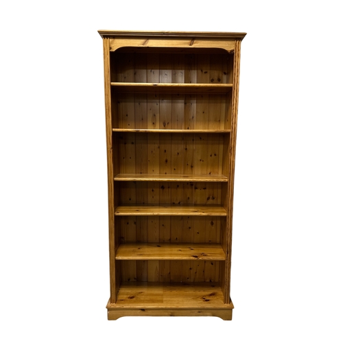 815 - A modern pine open bookcase with an arrangements of five shelves, 82cms wide.