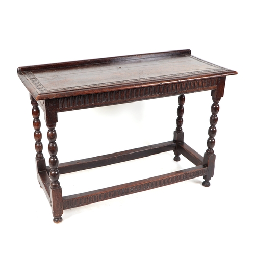 830 - A 17th century Jacobean oak side table, the rectangular top with shallow gallery and carved decorati... 