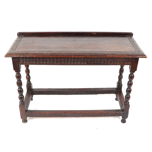 830 - A 17th century Jacobean oak side table, the rectangular top with shallow gallery and carved decorati... 