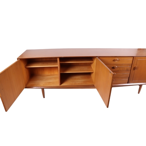 819 - A mid century modern 1960's teak sideboard with an arrangement of four central drawers flanked by a ... 