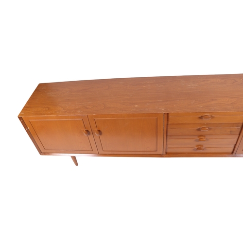 819 - A mid century modern 1960's teak sideboard with an arrangement of four central drawers flanked by a ... 