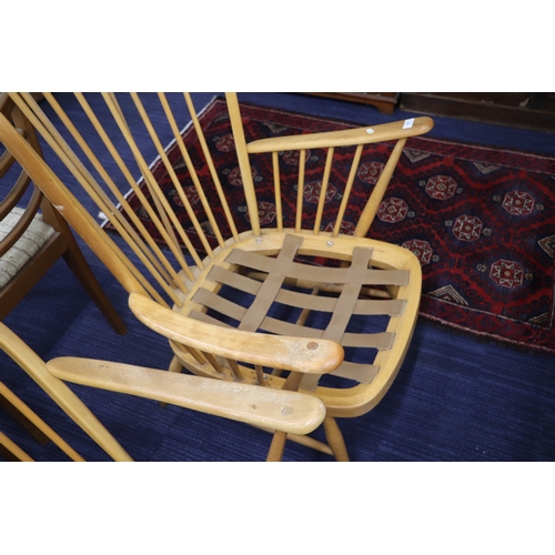 838 - A mid century blonde Ercol stick back armchair.