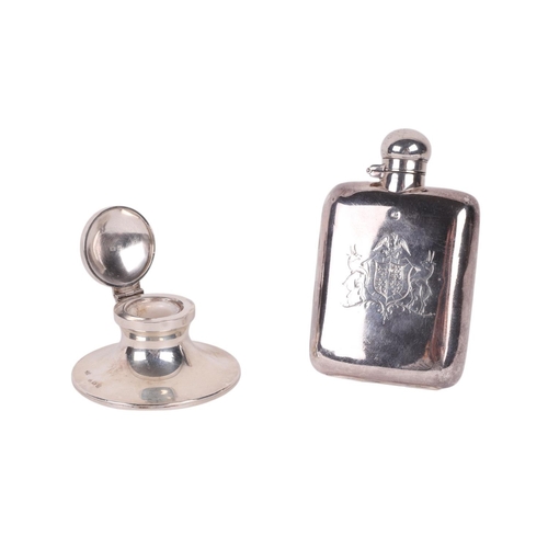 1108 - A small silver hip flask with engraved armorial decoration, 10.5cms high, 93g; together with a silve... 