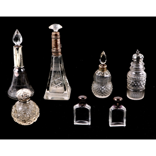 1148 - A group of silver mounted scent bottles, dressing table jars and a Georgian silver topped pepper pot... 