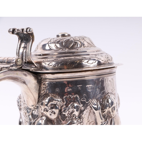 1150 - A large George I silver lidded tankard with embossed Bacchanalian figures in a procession, London 17... 