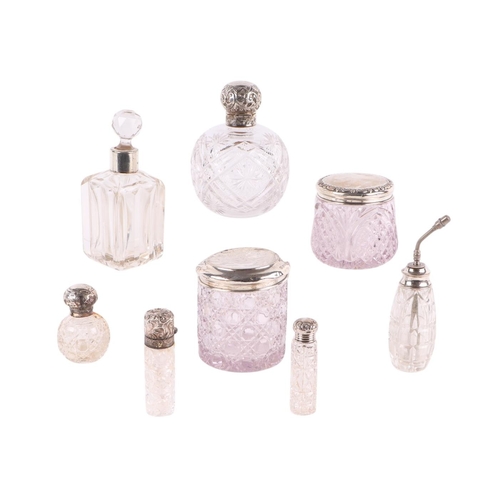 1156 - A group of silver topped and silver mounted dressing table jars and scent bottles, various dates and... 