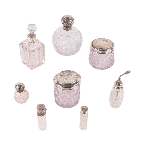 1156 - A group of silver topped and silver mounted dressing table jars and scent bottles, various dates and... 