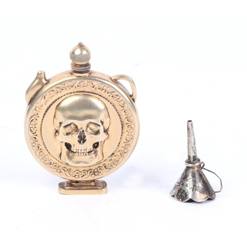 1169 - A Russian silver gilt poison flask with skull motif, 5.5cms high; together with an associated fillin... 