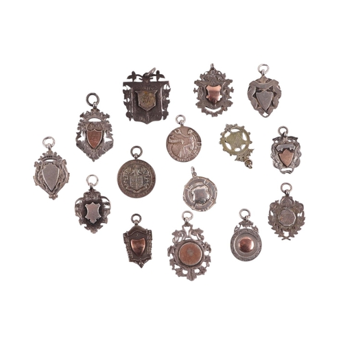 1173 - A large quantity of silver pocket watch fobs, some with gold mounts, various dates and makers marks,... 