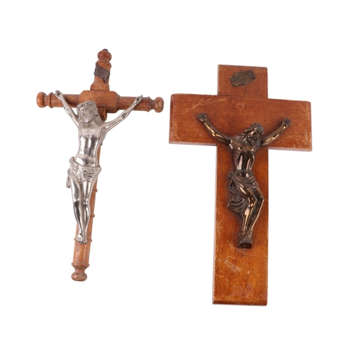 1650 - A Corpus Christi mounted on a wooden cross, 46cms high; together with another 47cms high (2).