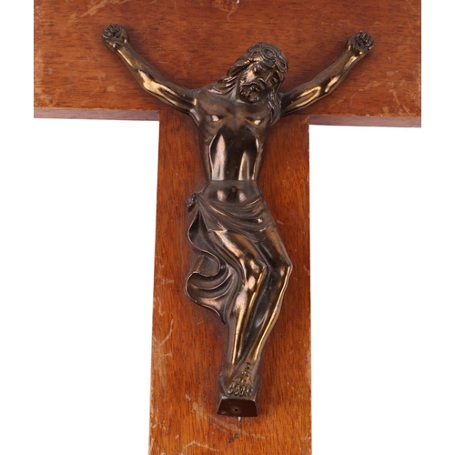 1650 - A Corpus Christi mounted on a wooden cross, 46cms high; together with another 47cms high (2).