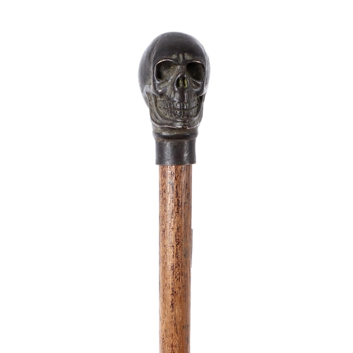 1653 - A vintage walking stick with bronze skull handle, 100cms long.