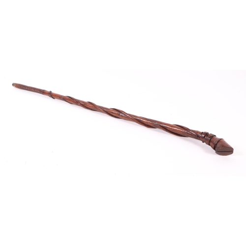 1656 - A folk art walking stick, the shaft carved with entwined snakes, the terminal in the form of a clove... 