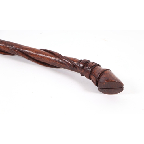 1656 - A folk art walking stick, the shaft carved with entwined snakes, the terminal in the form of a clove... 