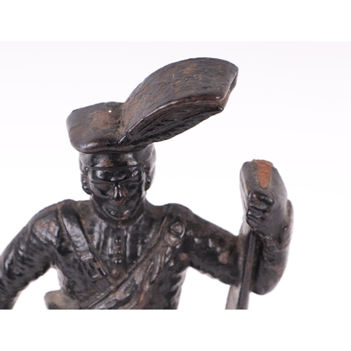 1711 - A Victorian cast iron door stop in the form of a highlander, 35cms high.