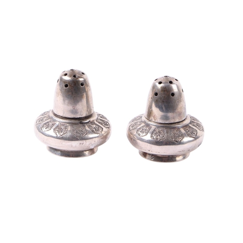 1823 - A pair of Persian silver pepperettes with repousse decoration, marks to base, 53g (2).