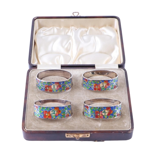 1824 - A boxed set of four silver and enamel napkin rings by Bernard Instone.