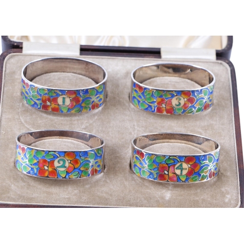 1824 - A boxed set of four silver and enamel napkin rings by Bernard Instone.