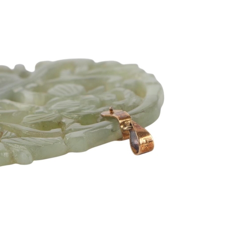 1941 - A Chinese pierced jade / hardstone pendant with 14ct gold suspension loop stamped 14K, 6cms high.