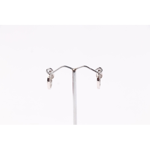 1943 - A pair of 18ct white gold diamond set hoop earrings, 2.3g.