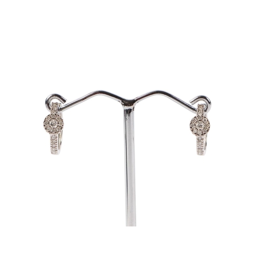 1943 - A pair of 18ct white gold diamond set hoop earrings, 2.3g.