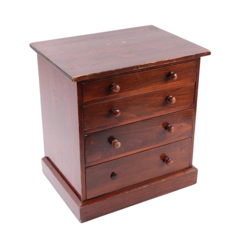 2284 - A late 19th century stained pine apprentice or collector's chest with four graduated long drawers, o... 