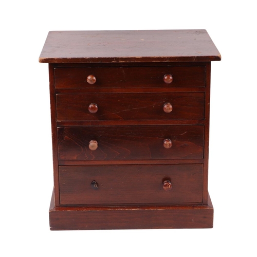 2284 - A late 19th century stained pine apprentice or collector's chest with four graduated long drawers, o... 