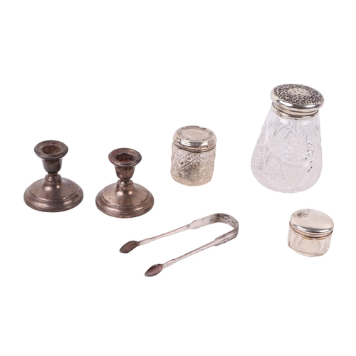 A pair of weighted silver dwarf candlesticks; together with two silver ...