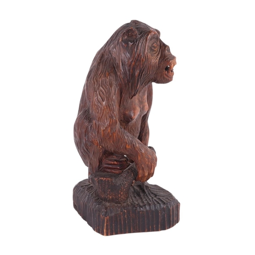 242 - A Black Forest style carving of a gorilla standing on a rocky plinth, signed 'F Wolf to rear, remnan... 