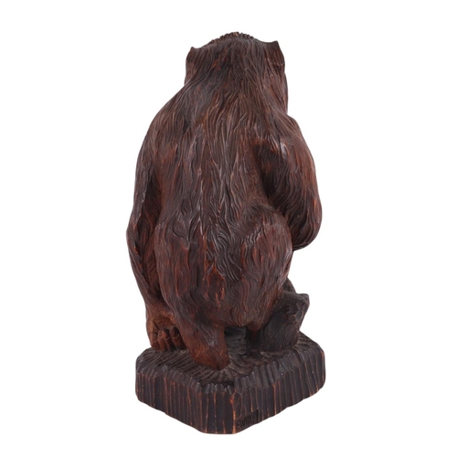 242 - A Black Forest style carving of a gorilla standing on a rocky plinth, signed 'F Wolf to rear, remnan... 