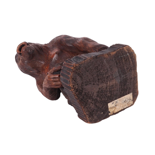 242 - A Black Forest style carving of a gorilla standing on a rocky plinth, signed 'F Wolf to rear, remnan... 