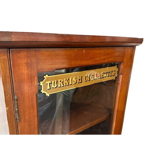 2523 - A mahogany shop display cabinet, the glazed door with gilt lettering 'Turkish Cigarettes', 59cms wid... 