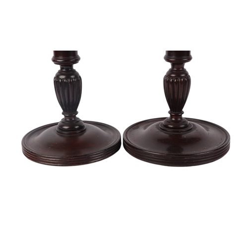 259 - A matched pair of mahogany table lamp bases with turned and reeded columns, on circular bases, 53cms... 