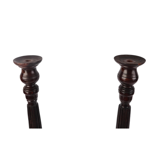 259 - A matched pair of mahogany table lamp bases with turned and reeded columns, on circular bases, 53cms... 