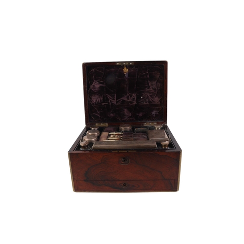 261 - A Victorian brass bound rosewood toilet box with fitted interior containing silver mounted jars and ... 