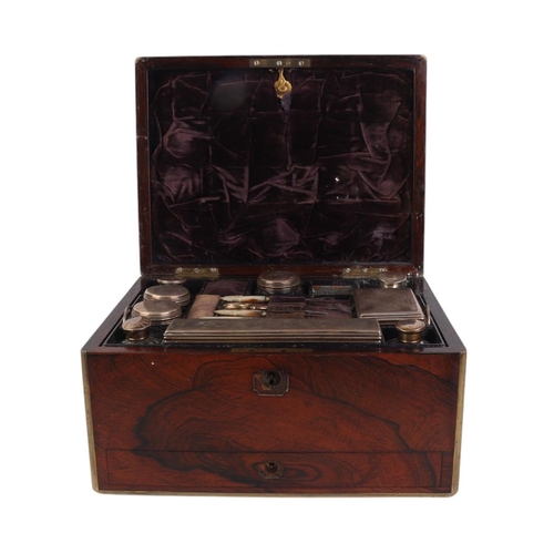 261 - A Victorian brass bound rosewood toilet box with fitted interior containing silver mounted jars and ... 