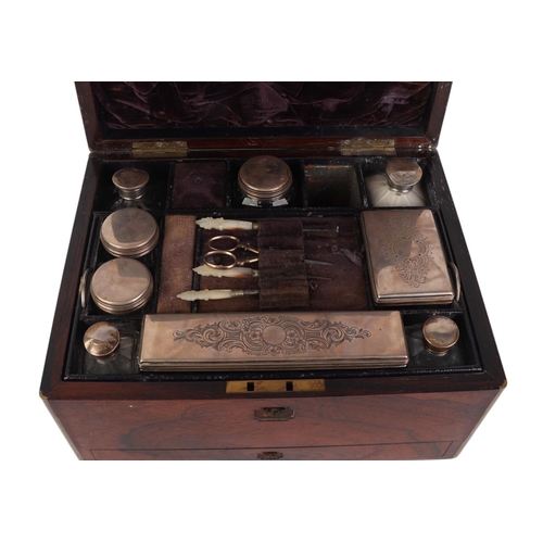 261 - A Victorian brass bound rosewood toilet box with fitted interior containing silver mounted jars and ... 