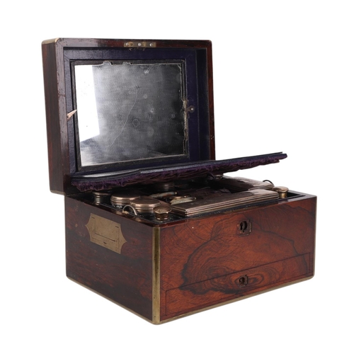 261 - A Victorian brass bound rosewood toilet box with fitted interior containing silver mounted jars and ... 