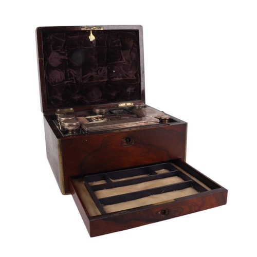 261 - A Victorian brass bound rosewood toilet box with fitted interior containing silver mounted jars and ... 