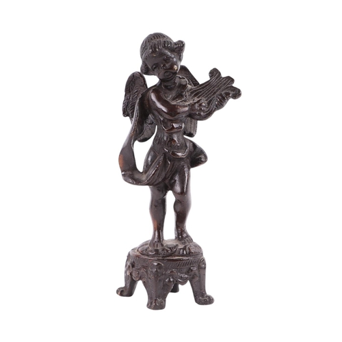 274 - After the antique:  A bronze figure of a cherub, mounted on a turned wooden socle, 21cms high; toget... 